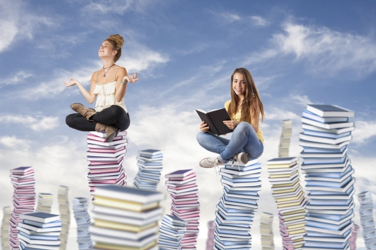 girls-sitting-mountains-books